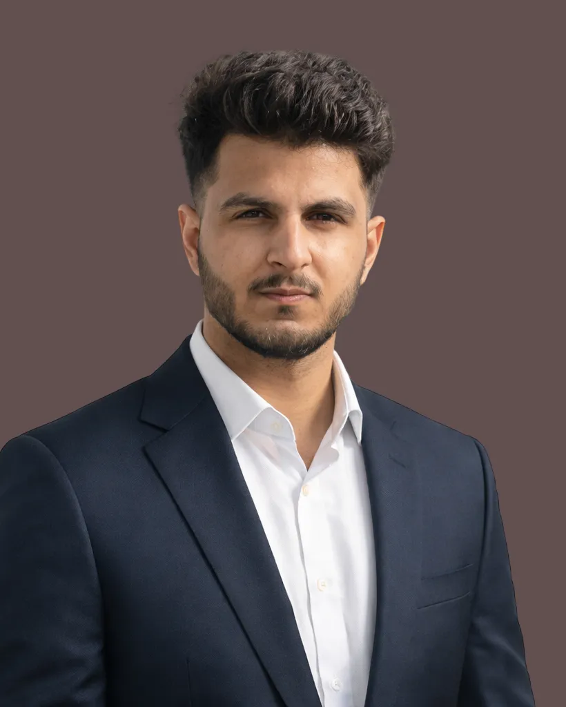 Founder of Mars Centrix, the AI automation studio, in a dark suit against a warm brown background